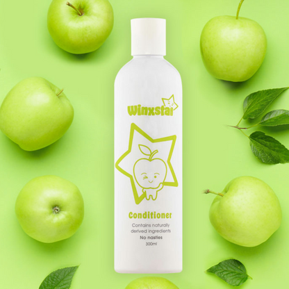 Winxsta Kids conditioner 300ml - white bottle with cute apple character and star shown on the front. Bottle surrounded by green apples.