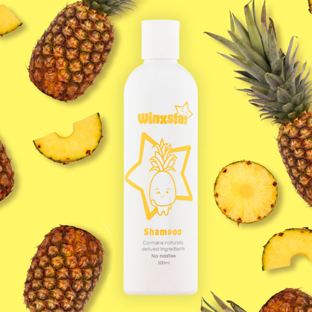 Winxsta Kids shampoo 300ml - white bottle with cute pineapple character and star shown on the front. Bottle surrounded by pineapples.